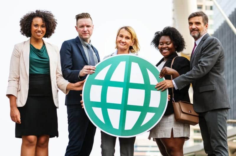 Team of MSPs holding globe
